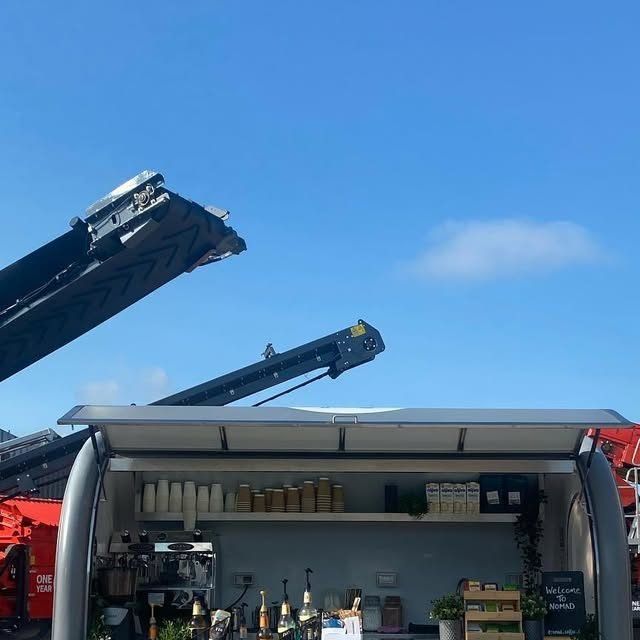 The Nomad van at a construction showcase with diggers behind