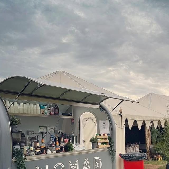 The Nomad van serving iced lattes in the VIP area at CarFest