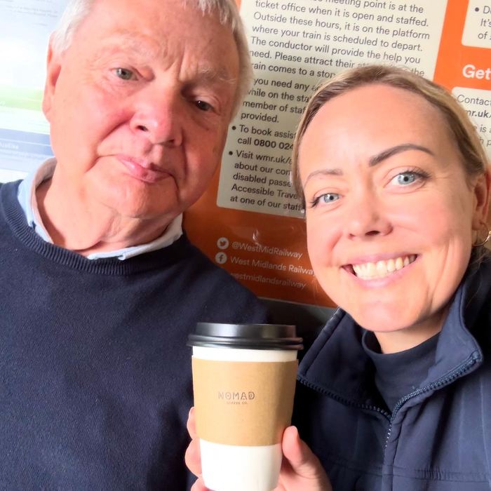 Cat with a regular customer holding a Nomad cup at Redditch station